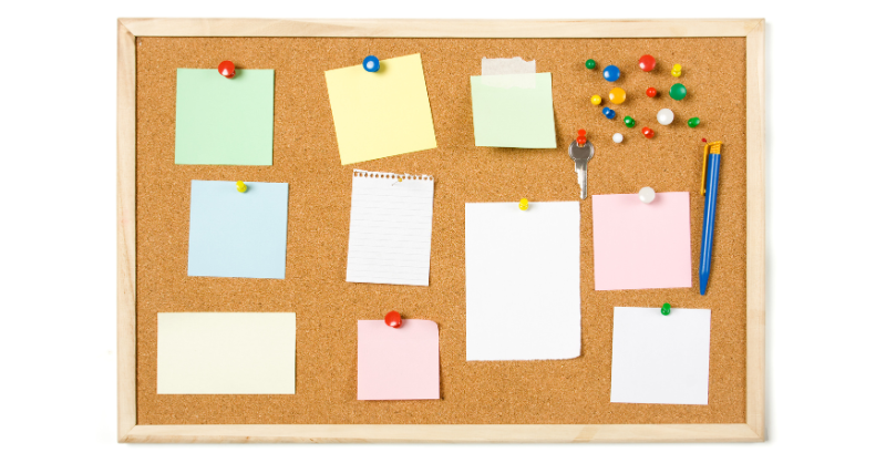 Cork bulletin board with post it and posters